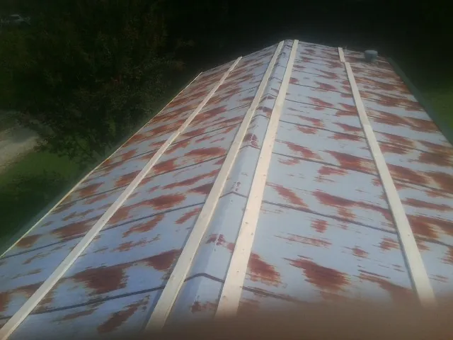 Rusted metal roof panels with new wood purlins before replacement — Storm Damage Roof Repair in Mashpee by Roofing Brothers