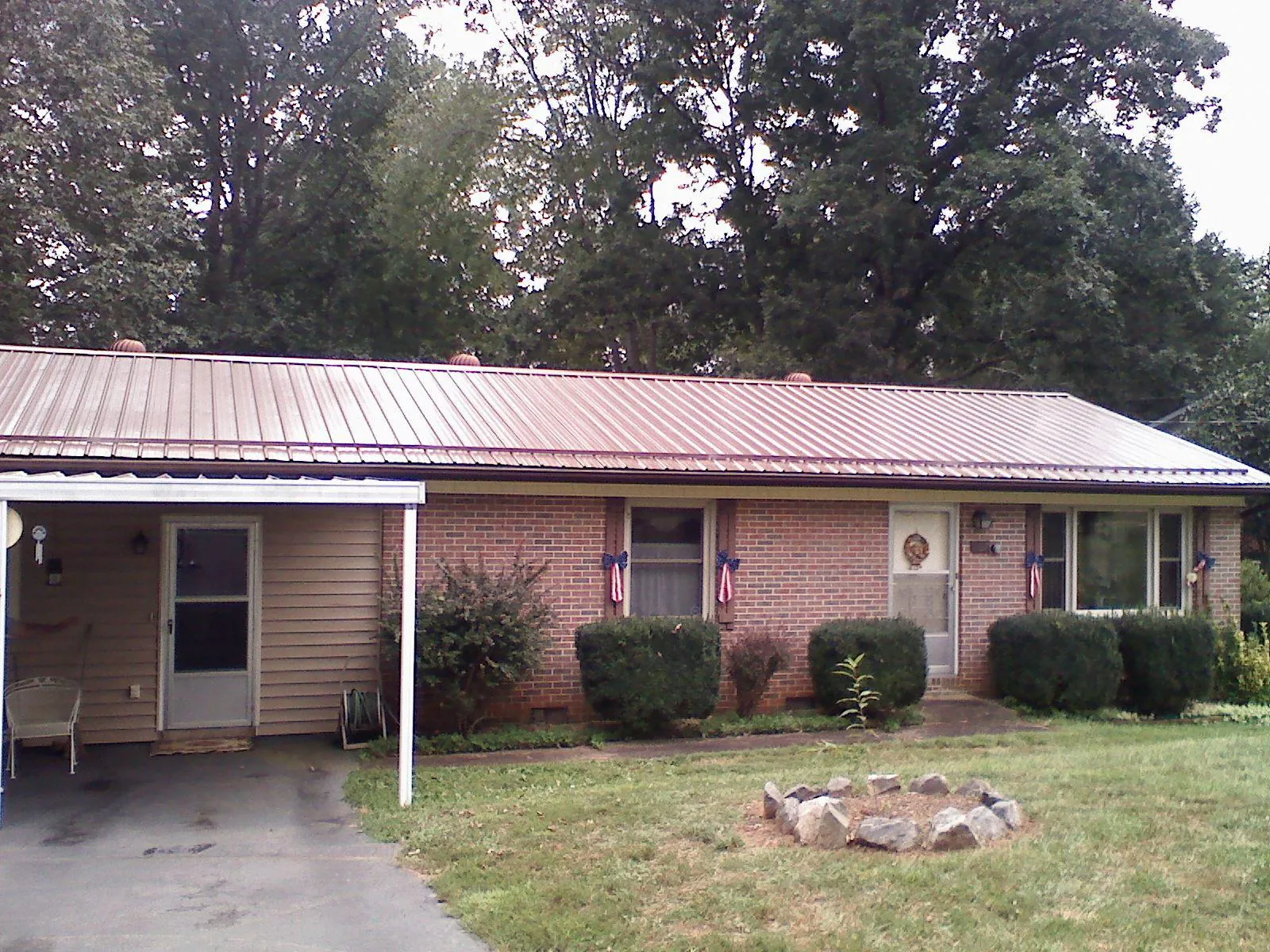 Bronze metal roof and carport on a brick ranch home — Roof Repair work by our crew in Mashpee